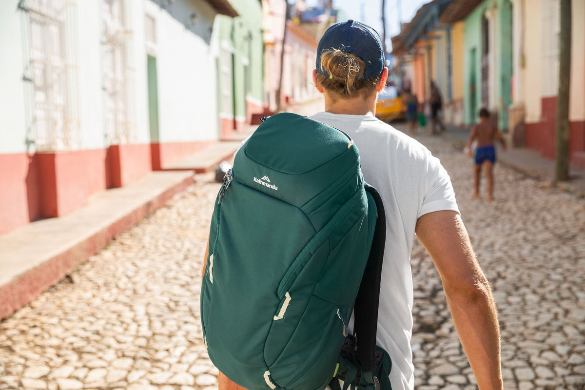 A man is carrying a Kathmandu day pack through the streets of Cuba.